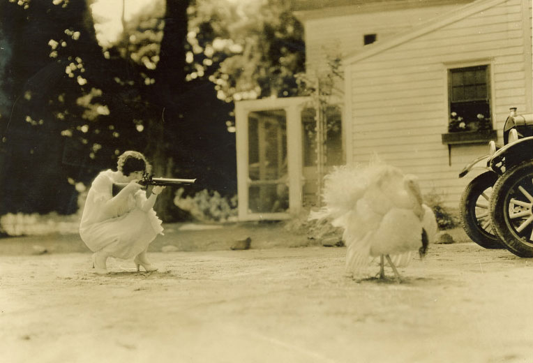 Woman aiming gun at turkey, 1920s | Traveling Culture: Circuit Chautauqua in the Twentieth Century