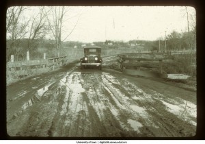 Automobile crossing a bridge on a dirt road, Iowa, 1922