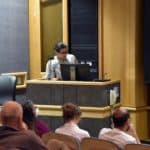 A graduate student presents at a podium